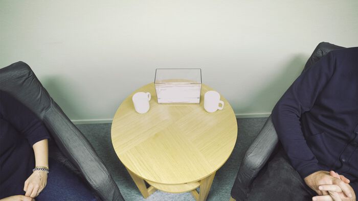 Two people from above in an interview setting.